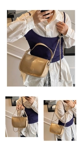 Detail of beige patent leather pillow bag with metal chain strap and top handle