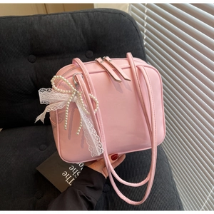 Pink pillow shoulder bag with double zipper and elegant pearl lace bow charm detail
