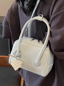 Light blue pleated faux leather pillow bag with pearl bow charm and detachable strap