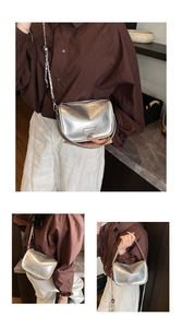 Detail of silver metallic pillow bag featuring adjustable chain strap and crinkled texture