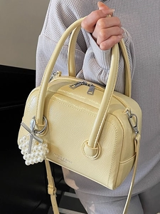 Pastel yellow pillow handbag with pearl heart charm and crossbody strap for women