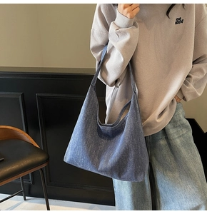 Detail of blue denim hobo bag showing high-quality washed texture and large capacity