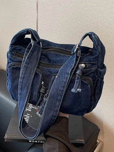 Retro dark blue denim shoulder bag with multi-zipper pockets and contrast stitching