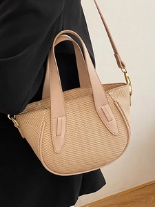 Minimalist straw bucket bag with leather handles and gold hardware for women