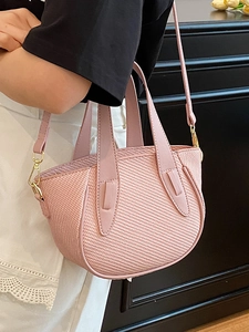 Pink woven bucket bag with leather handle and golden hardware for women's crossbody wear