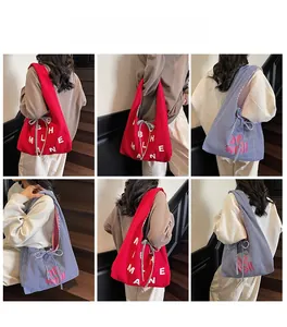 Detail of canvas tote bag featuring bow tie strap and stylish letter print design