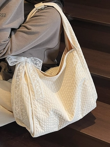 Beige large capacity tote bag with quilted texture and white lace bow detail