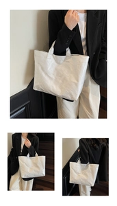 Detailansicht der weißen Tyvek-Einkaufstasche mit TOTE BAG Prägung und Knitteroptik