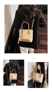 Detail of woven tote bag with brown leather trim, plush bear charm and checkered ribbon