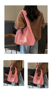Detail of red and white striped canvas tote bag with be well print and side drawstring bow