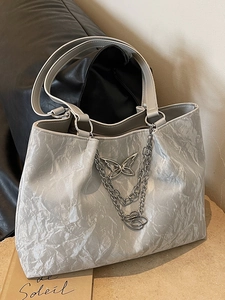 Chic silver pleated tote bag with metal butterfly and chain details for women