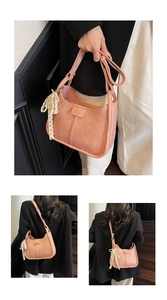 Pink matte crossbody bag with delicate pearl lace charm and adjustable strap detail