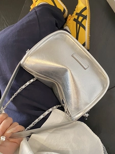 Silver metallic pleated pillow bag with chain strap and luxury logo detail for women