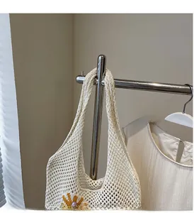 Close-up of cream crochet tote bag with sunflower accent and purple pearl detail
