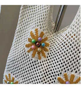 Detailed close-up of white crochet tote bag with yellow sunflowers and colorful beads