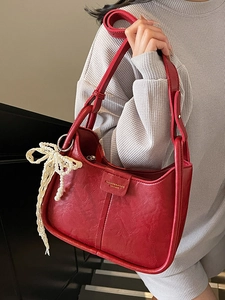 Retro red faux leather underarm bag with gold logo and pearl bow charm detail