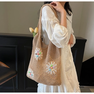 Detail of hand-woven hollow knit bag with 3D daisy embroidery and colorful beads