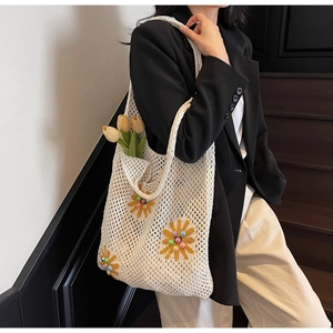 Detail of crochet hollow mesh tote bag with sunflower embroidery and colorful beads