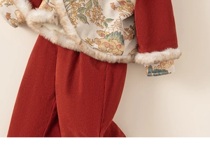 Detail of children's red New Year set with fur collar and traditional pattern