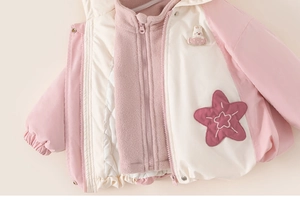 Detail view of girls fleece lined jacket with cute rabbit and star embroidery patches