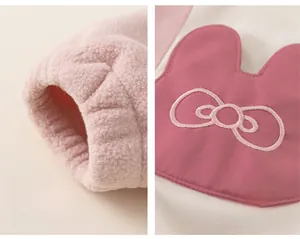 Detail of girls pink fleece jacket showing ribbed cuffs and bow embroidery on pockets