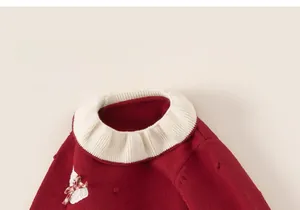 Detail of red knit dress with cream ruffle collar and cute rabbit embroidery patch