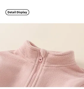 Close-up of pink fleece jacket neckline featuring a smooth matching resin zipper