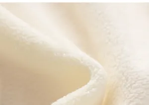 Close-up of soft pink thick polar fleece fabric texture for children winter sweater