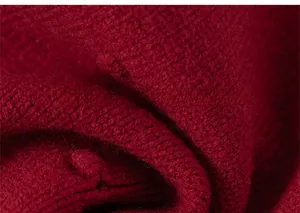 Detailed macro view of the soft red knit fabric texture for girls' sweater dresses