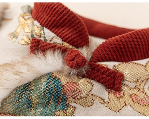 Close-up of traditional Chinese red stand collar with frog button and floral jacquard fabric
