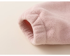 Detail of ribbed cuffs on pink fleece jacket with warm thickened fabric texture