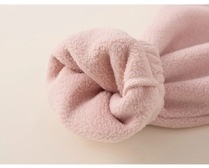 Detailed macro view of pink fleece fabric and stitched cuff for girls winter set