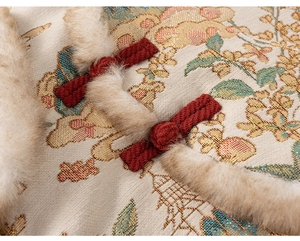 Detail of red brocade fabric with traditional knots and soft faux fur collar trim