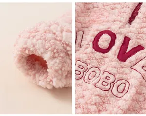 Close-up of pink fleece girl's sweatshirt featuring LOVE BOBO embroidery and ribbed cuffs