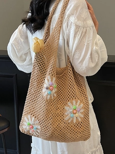 Beige crochet beach tote with white daisy flowers and colorful bead accents for women