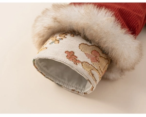 Close-up of red corduroy sleeve with faux fur trim and gold floral embroidery detail