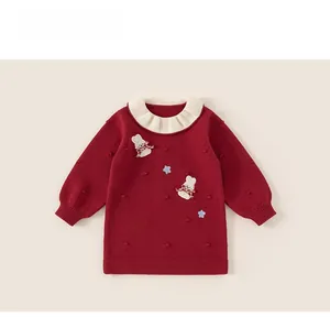 Close-up of girls red knitted dress with white ruffle collar and bunny embroidery