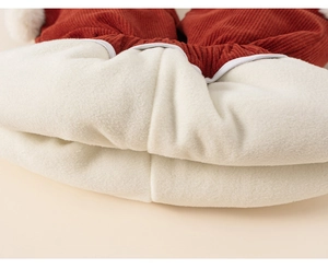 Close-up of thick white fleece lining and reddish-brown corduroy fabric detail
