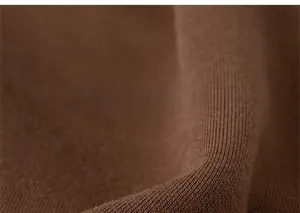 Close-up of brown thickened knit fabric texture on kids warm winter jogger pants