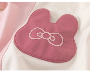 Detailed view of pink baby coat featuring rabbit ear applique and embroidered bow detail