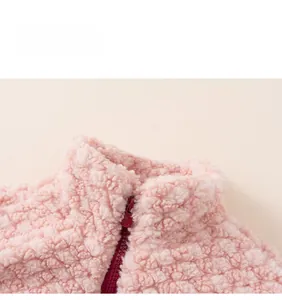 Detailed view of high neck pink fleece jacket with contrast zipper and soft texture