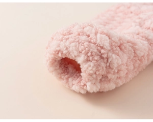 Macro close-up showing the soft pink plush velvet fabric and premium stitching detail