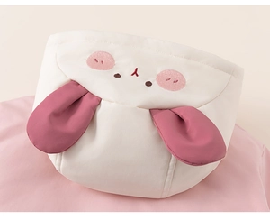 Detail of the cute rabbit-themed hood with pink 3D ears and embroidery on a warm coat
