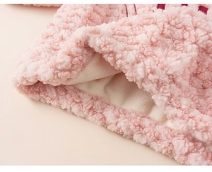 Close-up of pink sherpa fleece texture with warm thick inner lining on girls' top