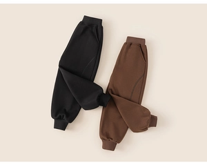 Detail of thick fleece-lined kids jogger pants in classic black and brown colors