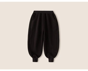 Detail of elastic waistband and thick cotton fabric on black boys' thermal joggers
