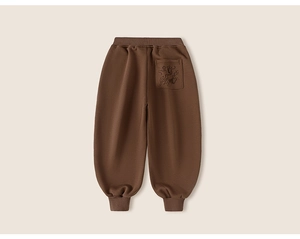 Detail of children's brown joggers showing elastic waist and back pocket embroidery