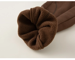 Detail of dark brown children trousers with thick fleece lining and ribbed cuffs