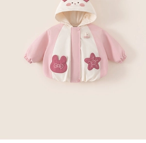 Close-up of pink hooded baby jacket featuring 3D animal ears and cartoon rabbit pockets