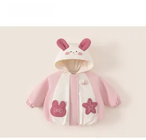 Detail of pink and white hooded kids jacket featuring cute rabbit ear hood and embroidery